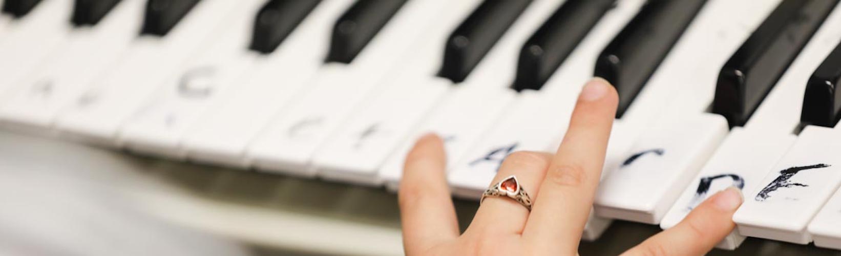 Student hand on piano keys